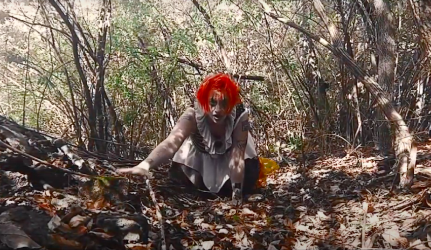 Creepy clown Ellie crawls through the woods
