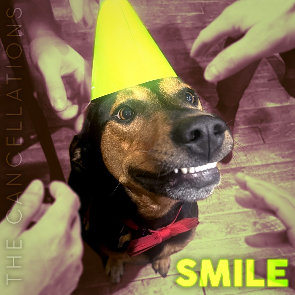 An album cover featuring a photo of a dog smiling (his top lip is stuck on his teeth). The dog is wearing a bright yellow-green party hat and a red bow tie. Several masculine hands are reaching for him from out of frame. In the bottom right corner is the word SMILE in all caps, in the same color as the dog's party hat. The name of the band, The Cancellations, lines the lefthand side of the photo.